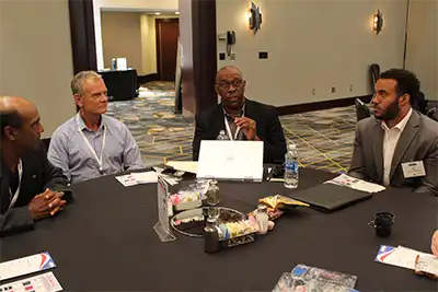 Dennis Daniel leading a discussion at an IT event.